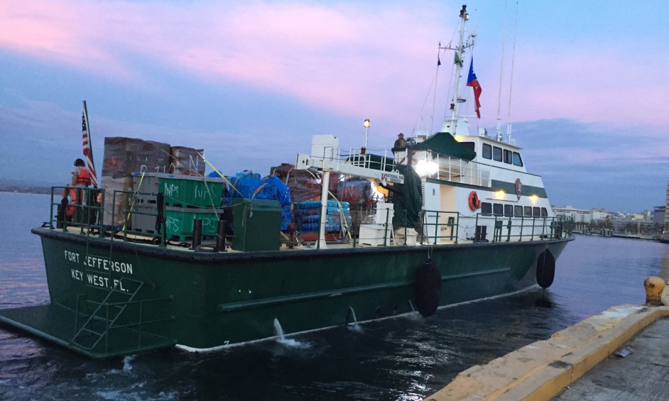 NPS MV Fort Jefferson departs San Juan to begin distributing emergency stabilization supplies and equipment to Caribbean parks. 110-foot vessel moving away from a dock carrying pallets of containers