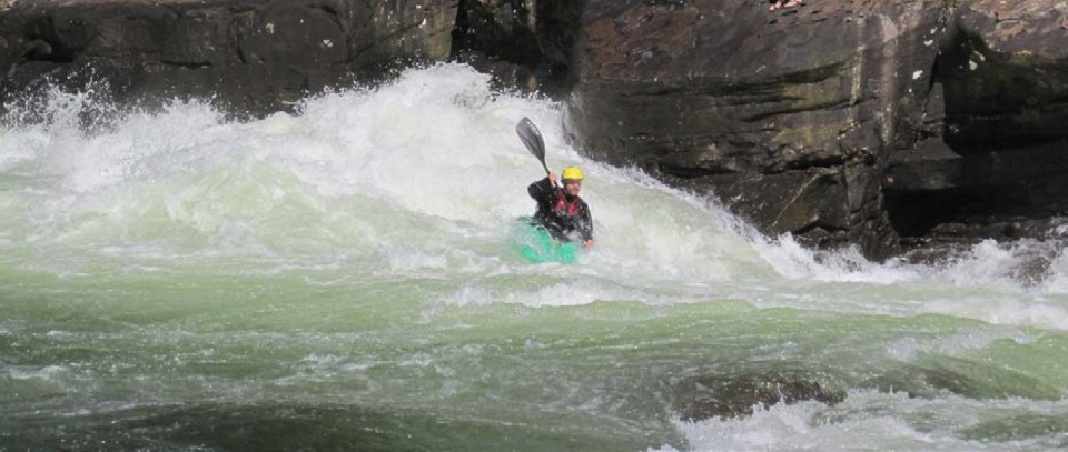 Whitewater paddler in rapids