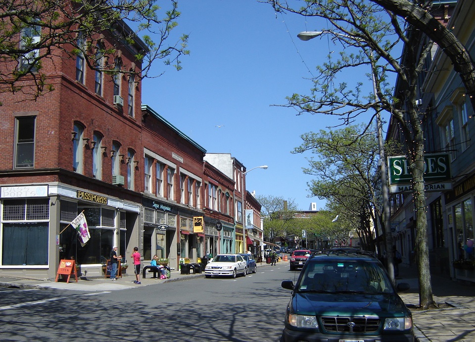 Line of shops in historic brick buildings on a small town downtown street