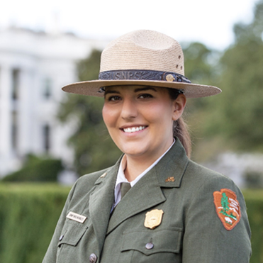 Jenny Anzelmo-Sarles in her uniform with trees in the background.