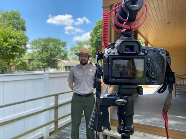 Park Ranger in front of a video camera recording a virtual program 