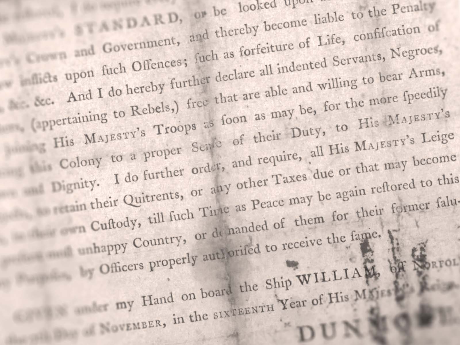 Closeup of printed proclamation signed with “Dunmore” in all capital letters in bottom right corner.