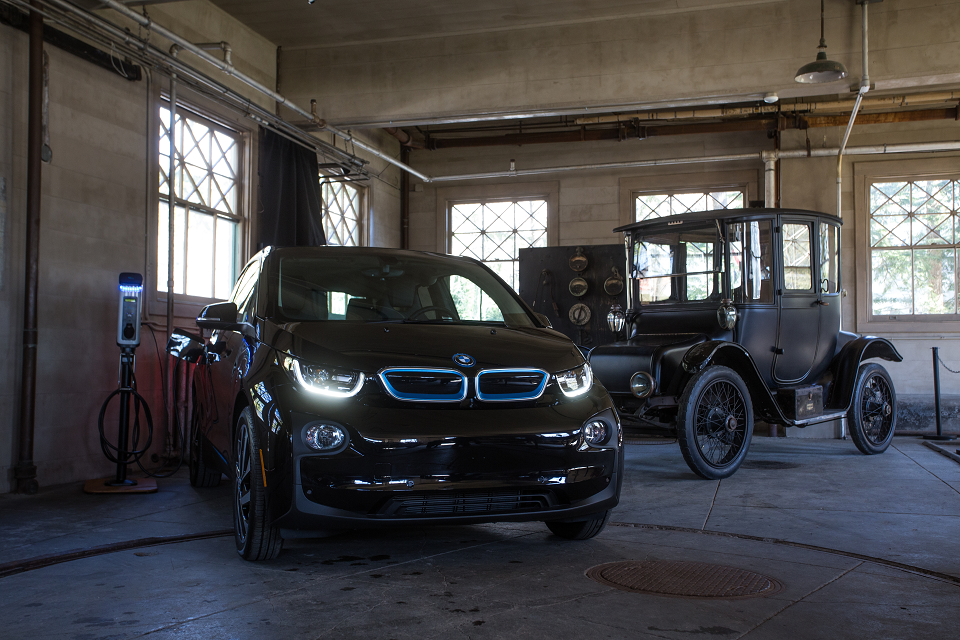 Modern electric vehicle (BMW i3 from 2017) and Edison owned early electric vehicle (Detroit Electric Model 47 from 1914) and their charging stations inside Edison's Glenmont garage at Thomas Edison National Historical Park.