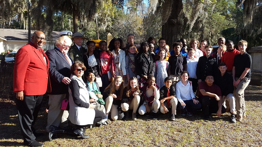 Director Jarvis, Congressman, and group of youth posing for the camera