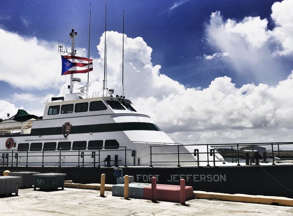 NPS Motor Vessel Fort Jefferson in San Juan Large vessel with multi-story cabin lined up next to a concrete dockside