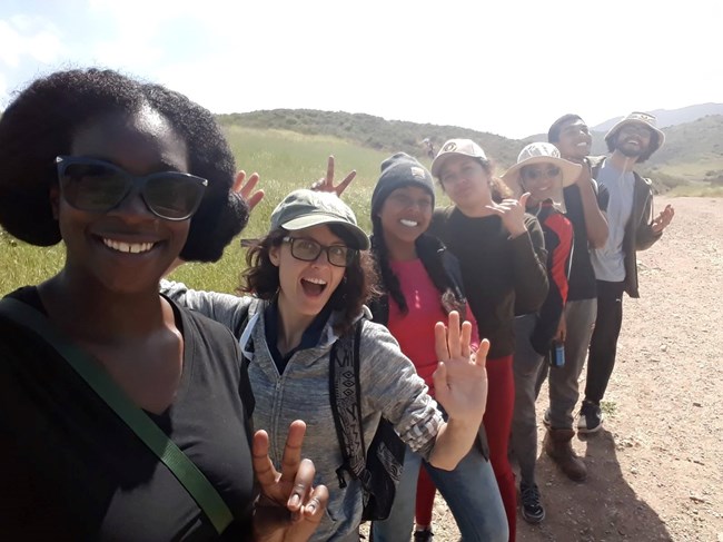 Line of young adults on a hike taking a selfie 