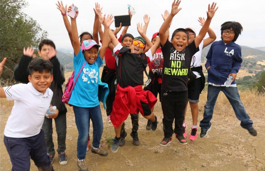 Group of kids jumping in the air with excitement