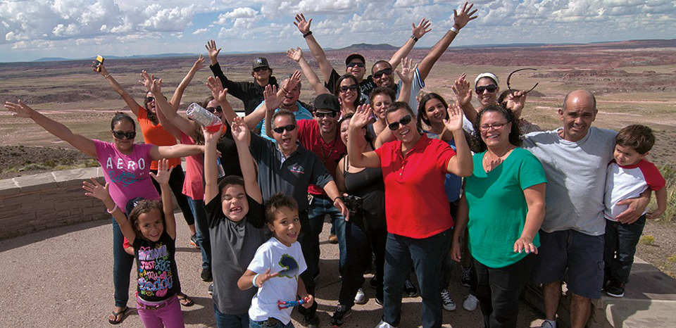 Group at Petrified Forest Group posing on patio with desert backdrop