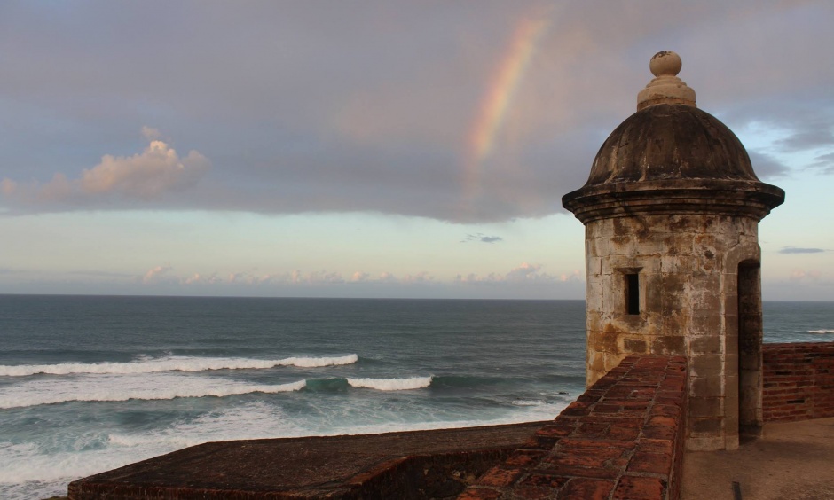 Historic masonry wall and structure with ocean in the background