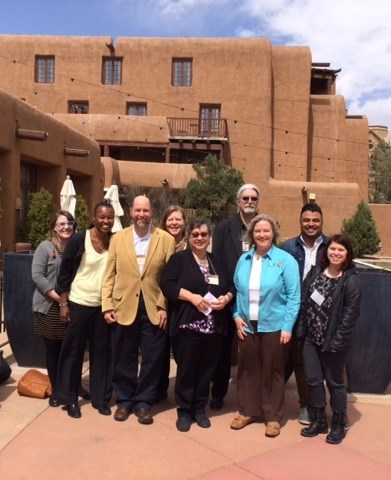 NPS Cultural Anthropologists and Research Partners Present at the SfAA Meetings, March 2017 Nine people standing in a group outside adobe building.