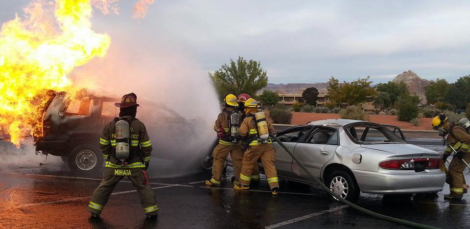 NPS firefighters extinguish a car fire at a fire training workshop.