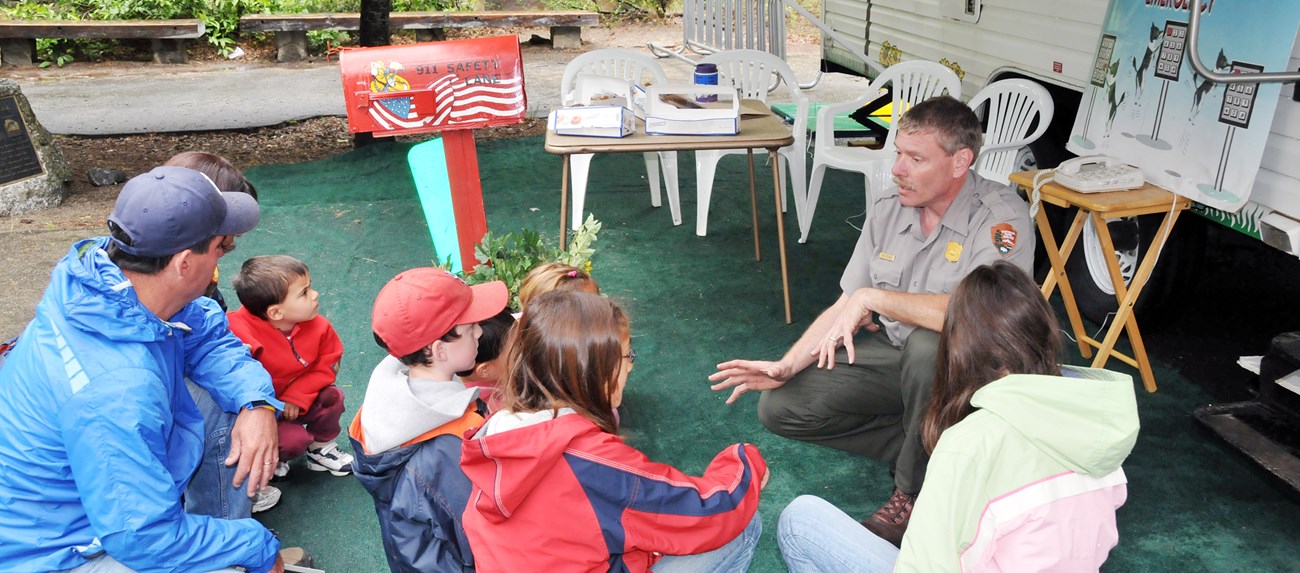 lt= Park ranger talks with family about fire safety