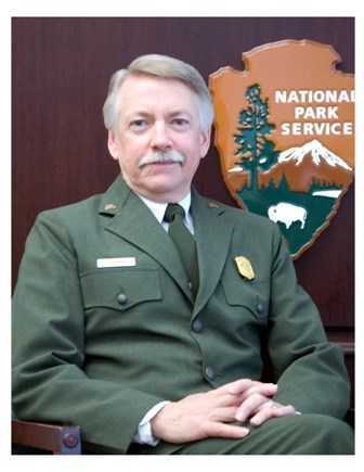 Director Jarvis sits posed in his park service uniform. Director Jarvis sits posed in his park service uniform.