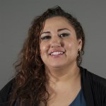 A smiling woman in a black shirt.