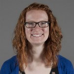 A woman with red hair and glasses. A woman with red hair and glasses.
