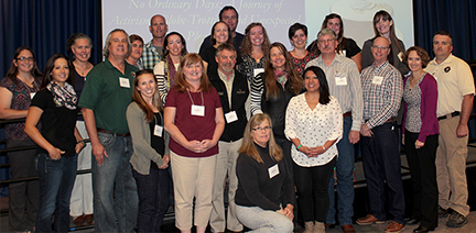 Women and Leadership Conference 2017 Attendees A group of women and men stand in front of a screen.