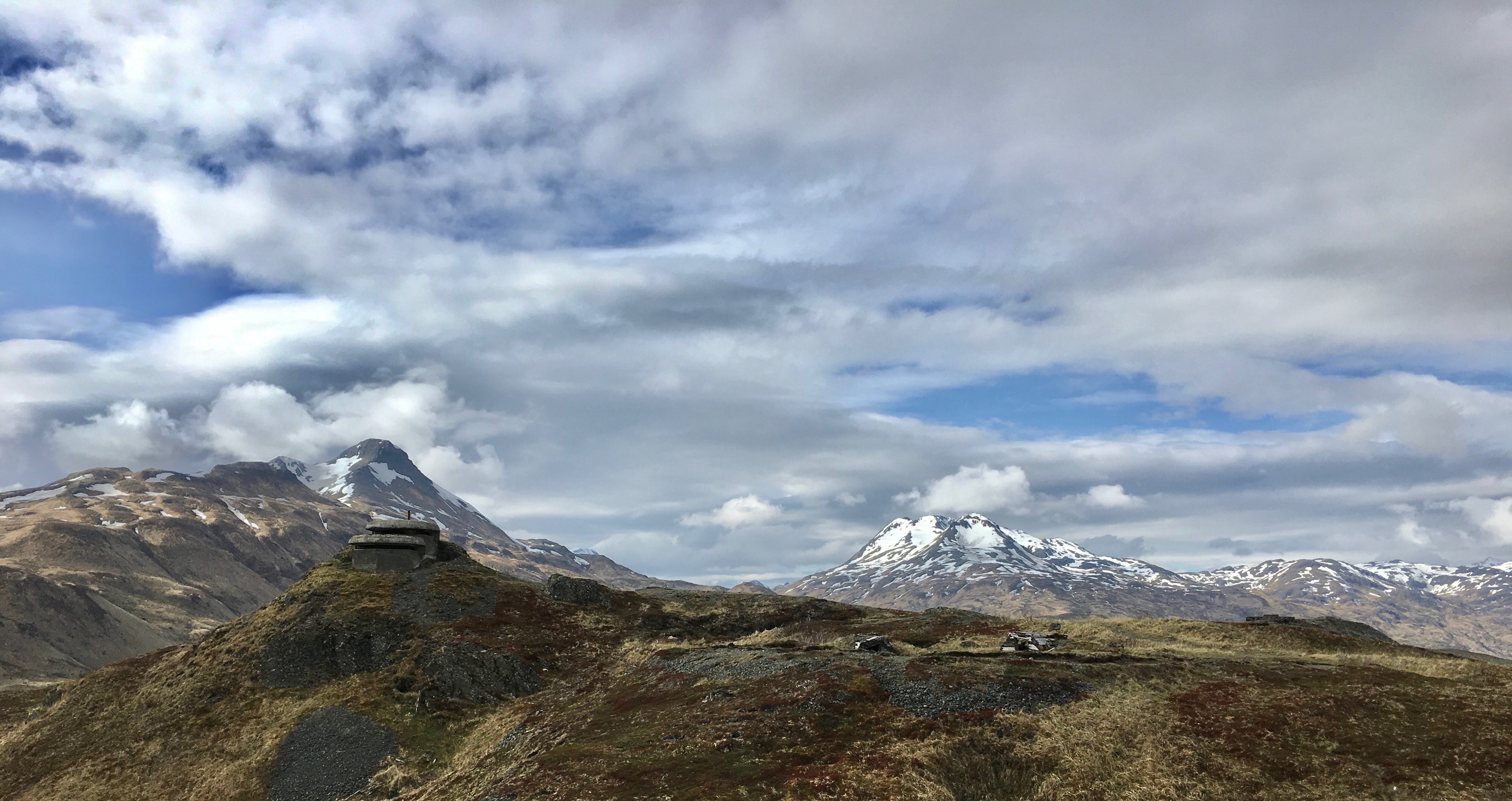 A photograph of a cement lookout and the remains of WWII structures at Fort Schwatka, Alaska