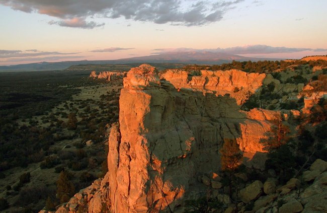 A landscape of sandstone rocks lit by sunlight