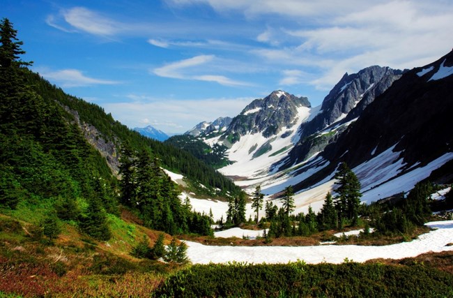 A snowy valley within a mountain pass.