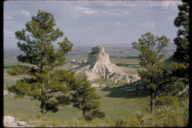 An 800 foot tower of rock sits in the midst of mixed grass prairie.