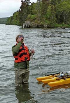 Scientist measuring discharge at Katmai National Park.
