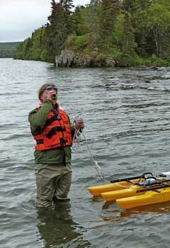 lt= Scientist measuring discharge at Katmai National Park.
