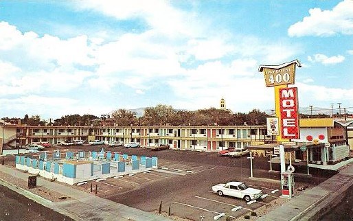 lt= A historic postcard depicting a 1950 style small motel.