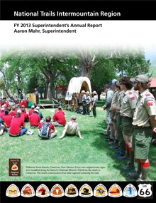 boy scouts on the grass and rangers standing at the Philmont Scout Ranch; lots of grass and trees