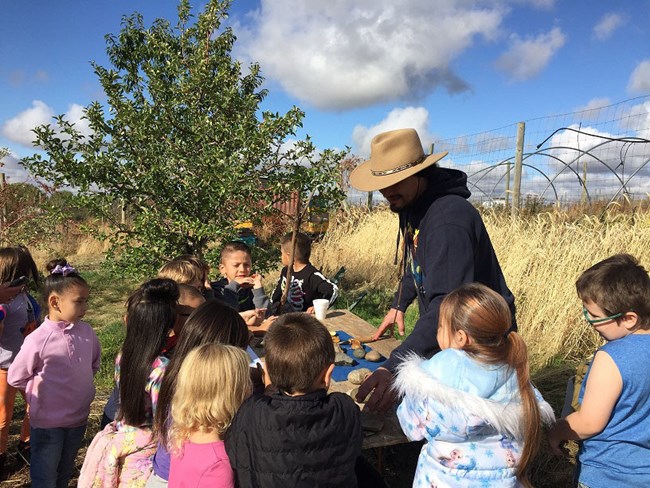 Deputy THPO Nicholas Kager is with a class of students from the Tribal School.