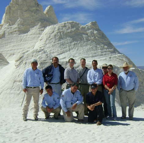 Group of rangers in front of sand formation
