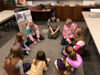 NPS Park Ranger speaks with a Girl Scout Troop NPS Park Ranger speaks with a Girl Scout Troop