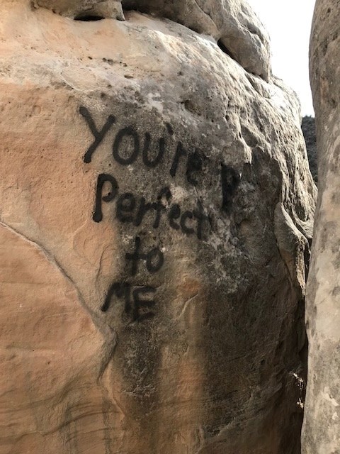 One of several rock walls in Colorado National Monument defaced by vandalism. NPS photo.