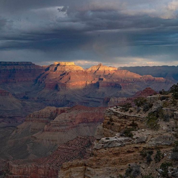 Looking east from Maricopa Point in Grand Canyon National Park, geologic formations Wotan's Throne and Vishnu Temple are illuminated by a beam of sunlight under stormy skies. NPS photo. Looking east from Maricopa Point in Grand Canyon National Park, geologic formations Wotan's Throne and Vishnu Temple are illuminated by a beam of sunlight under stormy skies. NPS photo.