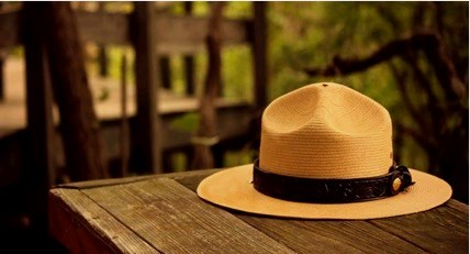 Seeking help when experiencing stress, depression, anxiety or suicidal thoughts is a sign of courage, not one of weakness. Seeking help for a colleague is an act of compassion and strength, not an act of disloyalty. The iconic "flat hat" of a US Park Ranger rests atop a wooden table.