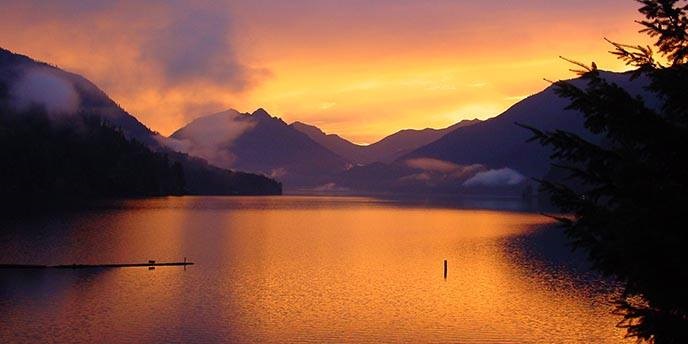 Sunlit skies are reflected on the water of Lake Crescent in Olympic National Park. NPS photo.