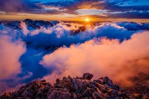 Sunshine breaks over clouds and mountain peaks in Rocky Mountain National Park. NPS photo by C Brindle.