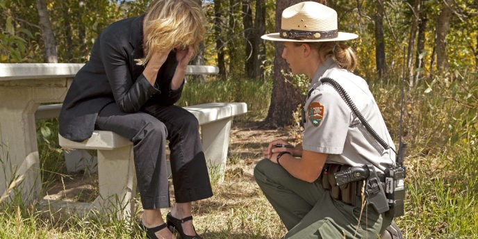 A US Park Ranger provides support to a distraught person.