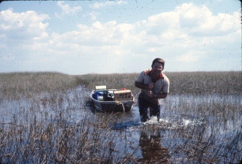 Contractor standing  in swamp
