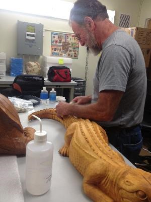 Conservator Al Levitan treating the John Segeren carvings from Everglades National Park Flamingo Museum