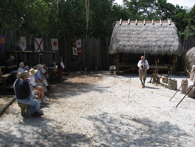 Costumed interpreter demonstrating sixteenth-century European weaponry to De Soto National Memorial visitors at the park's reconstructed Camp Uzita Costumed interpreter demonstrating sixteenth-century European weaponry to De Soto National Memorial visitors at the park's reconstructed Camp Uzita