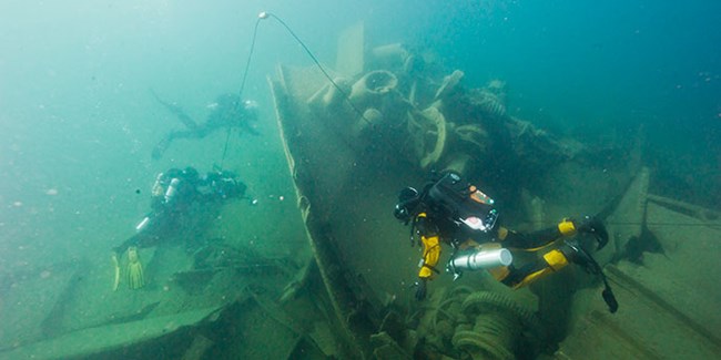 Divers underwater at the Glenlyon wreck