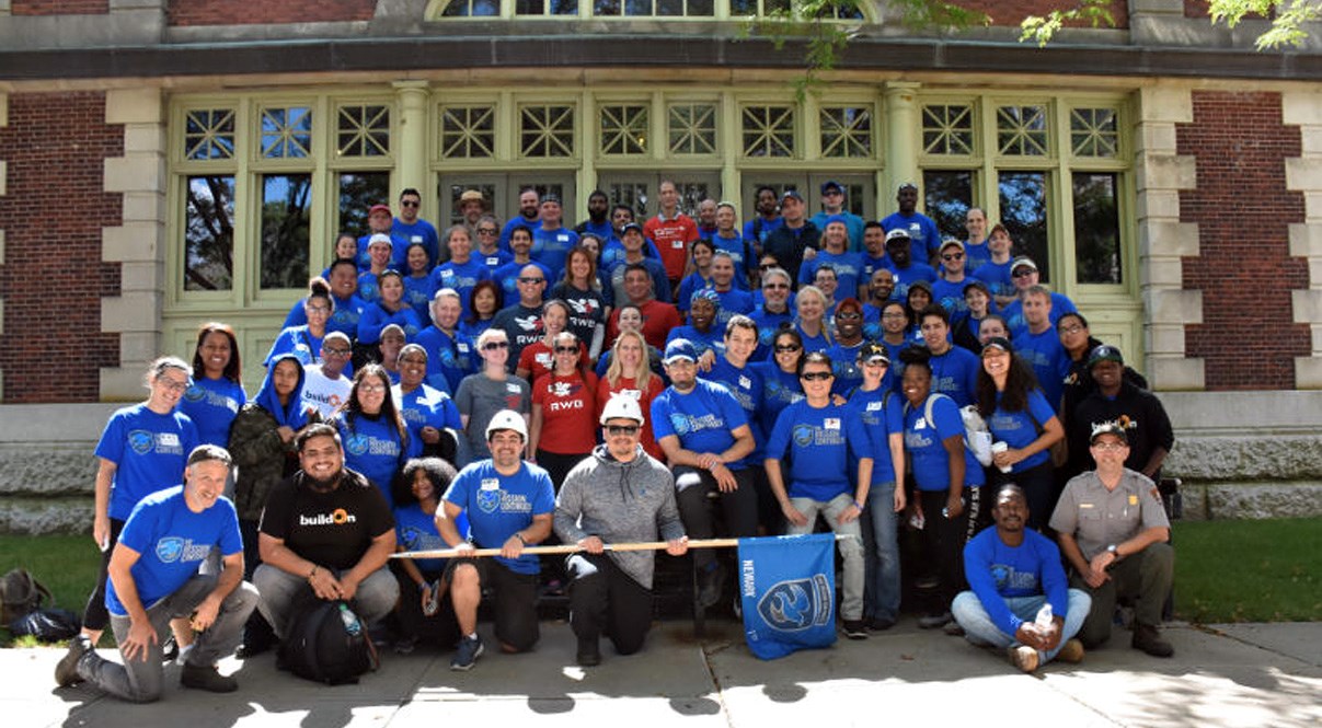 A large group of members from "The Mission Continues" pose for a photograph.