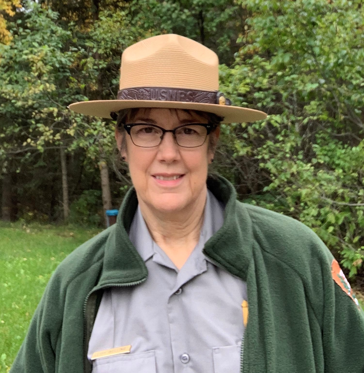 Welling Portrait Portrait of a woman in ranger uniform and flathat from chest up in front of trees