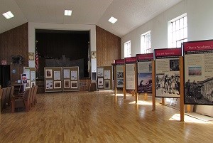 Exhibits along the right wall of a large indoor space