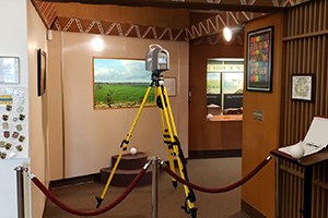 Terrestrial laser scanner on a tripod in an interior museum exhibit space