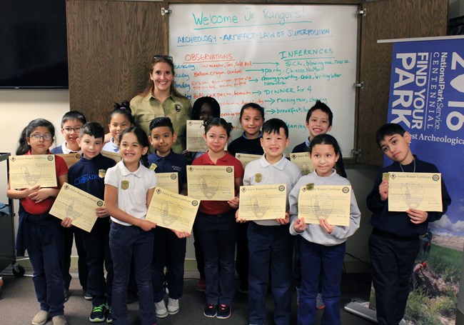 Group of new junior rangers showing off their certificates