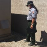 Bruce Kaeding A man in uniform looks at a building