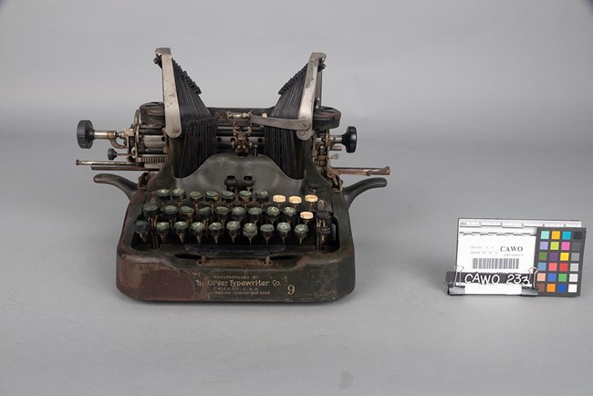 A worn black metal manual typewriter