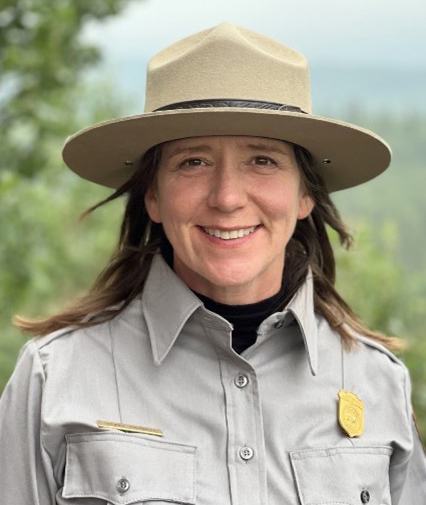 A woman in uniform smiling at camera