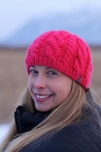 Deb Coble a woman in a pink winter hat smiles